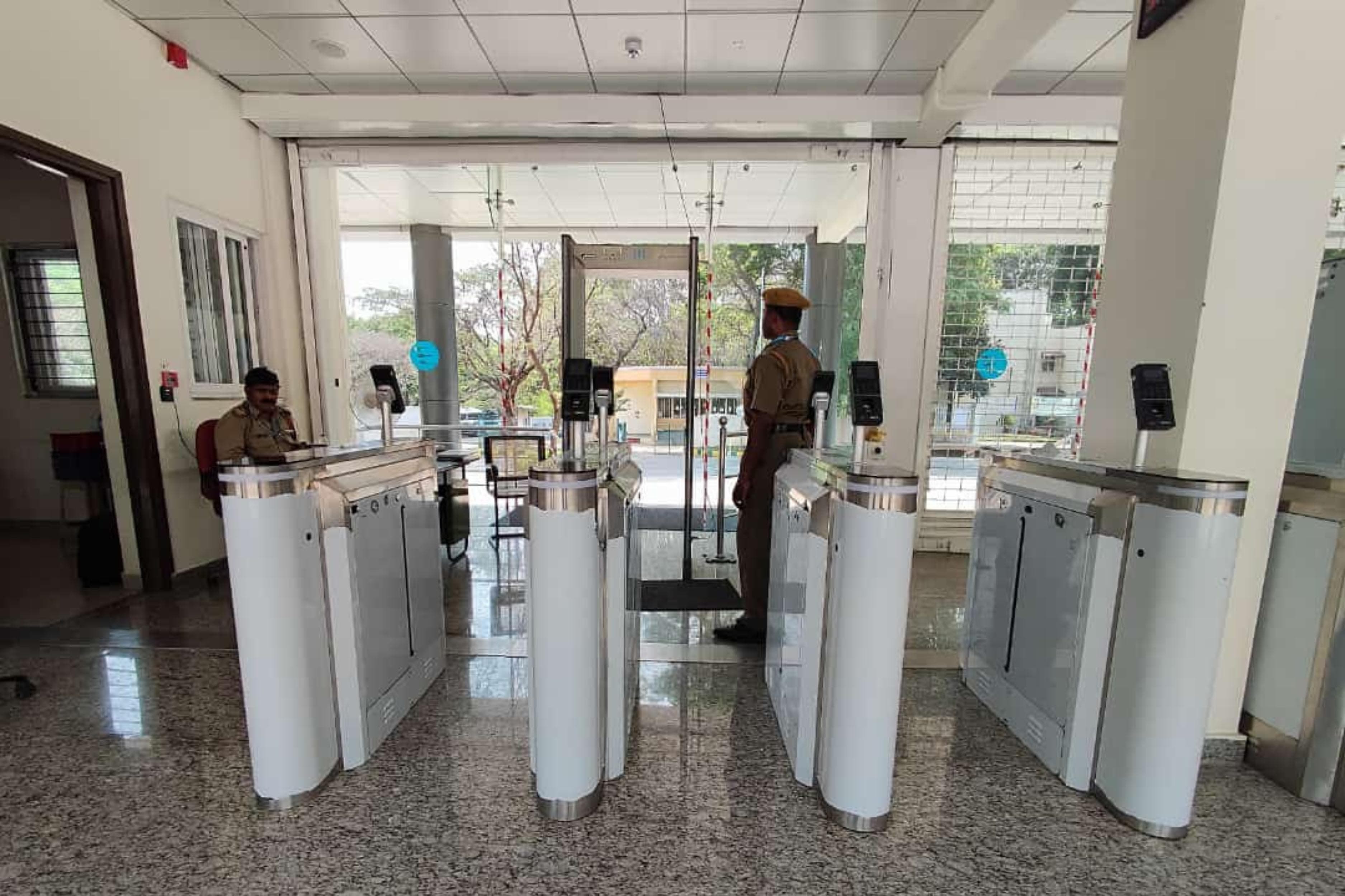 Swing barrier lanes with readers controlling pedestrian entry at a building lobby
